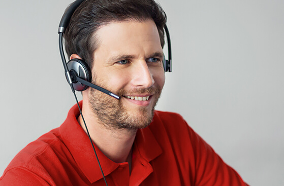 Callcenter-Mitarbeiter telefoniert mit Headset.