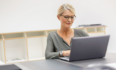 Frau sitzt am Laptop