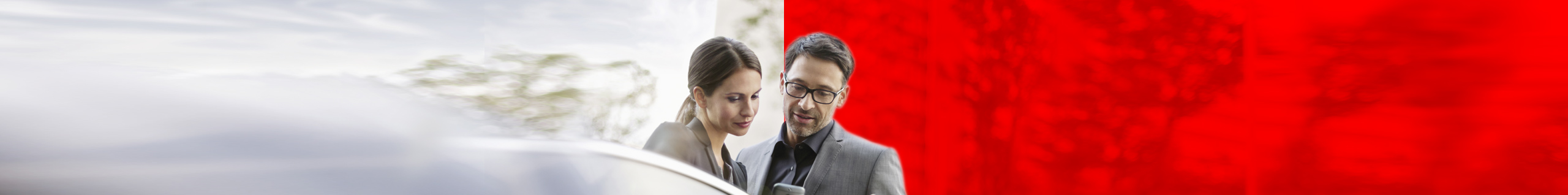 Arbeitskollegen mit einer Vodafone Cloud L&ouml;sung gucken auf ein Smartphone.